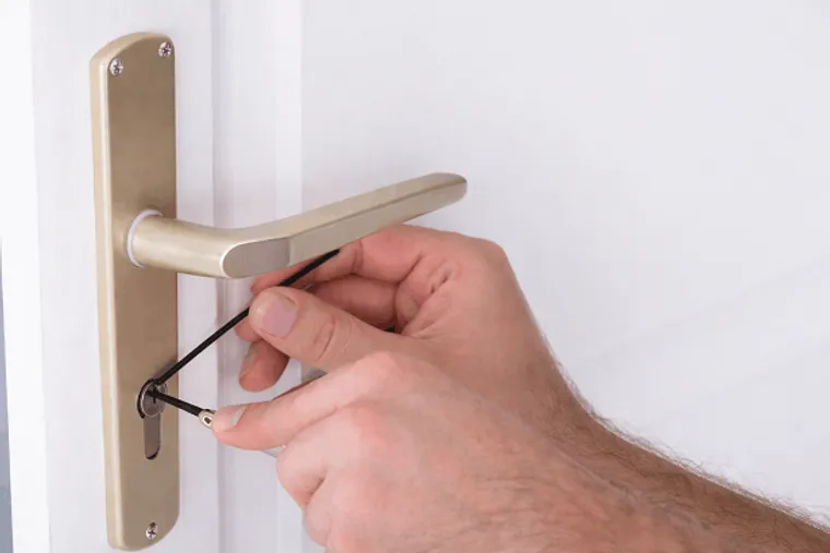 Locksmith working on a door lock in Canterbury